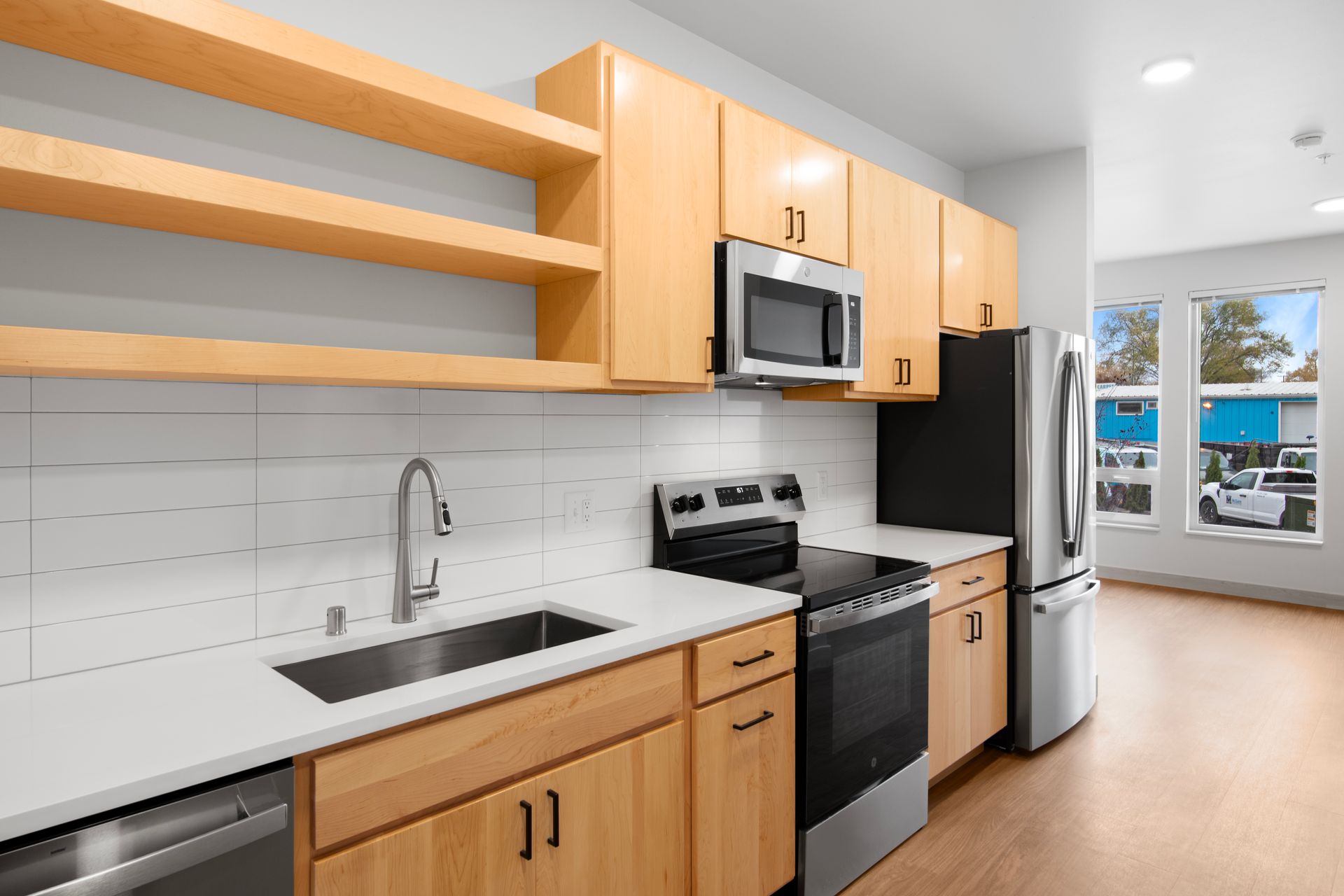 A kitchen with wooden cabinets and stainless steel appliances