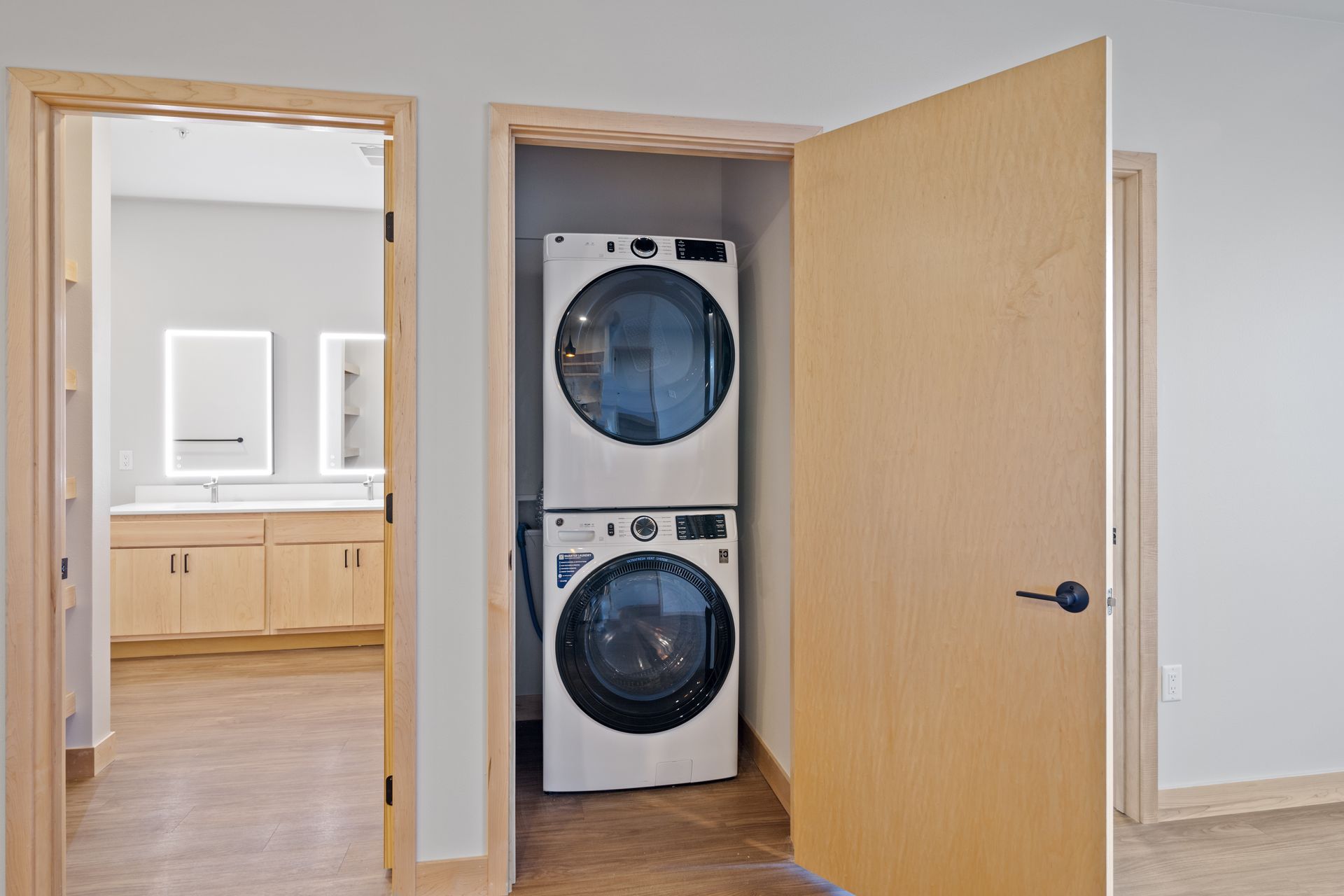 A washer and dryer are stacked on top of each other in a closet.