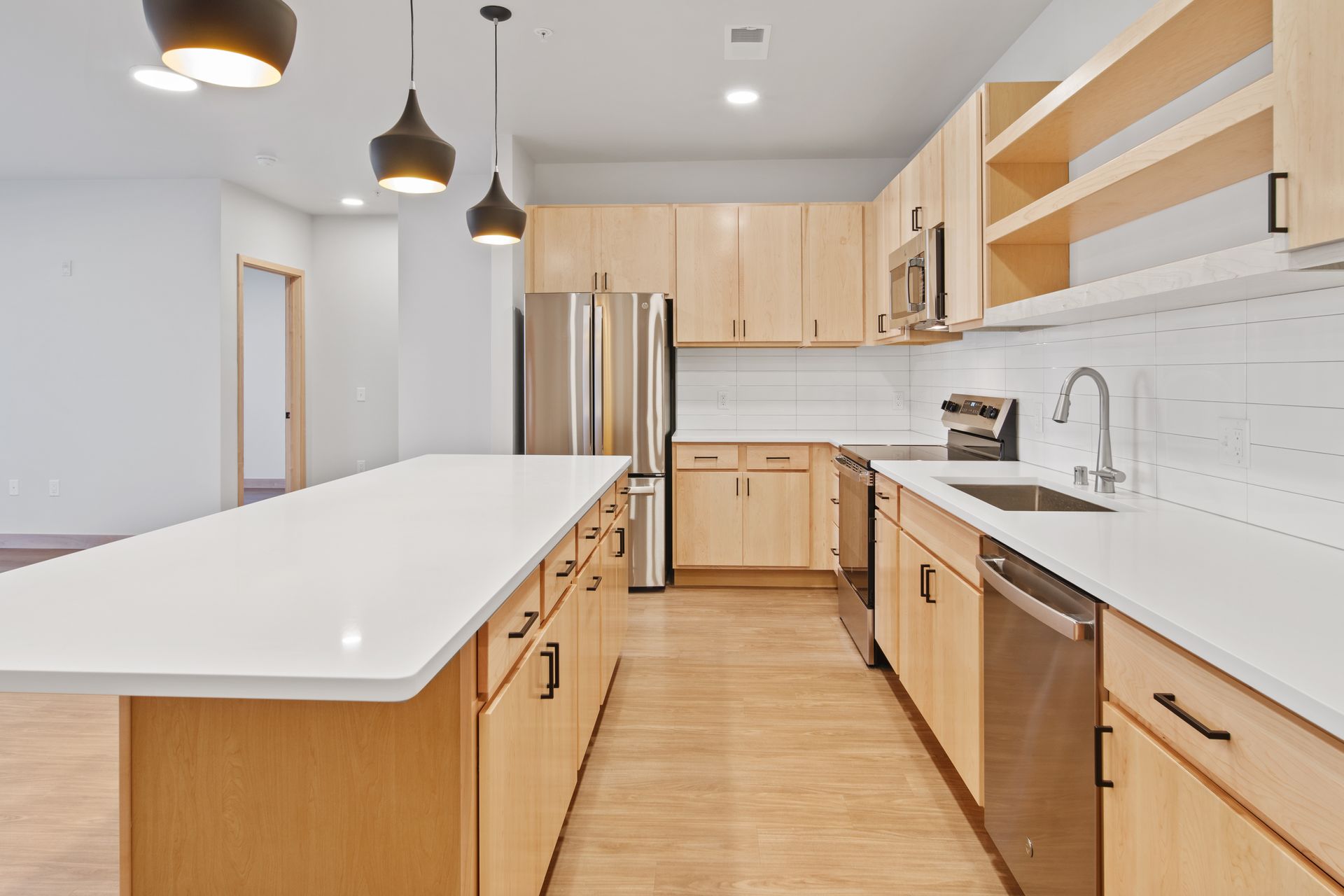 A kitchen with stainless steel appliances and wooden cabinets