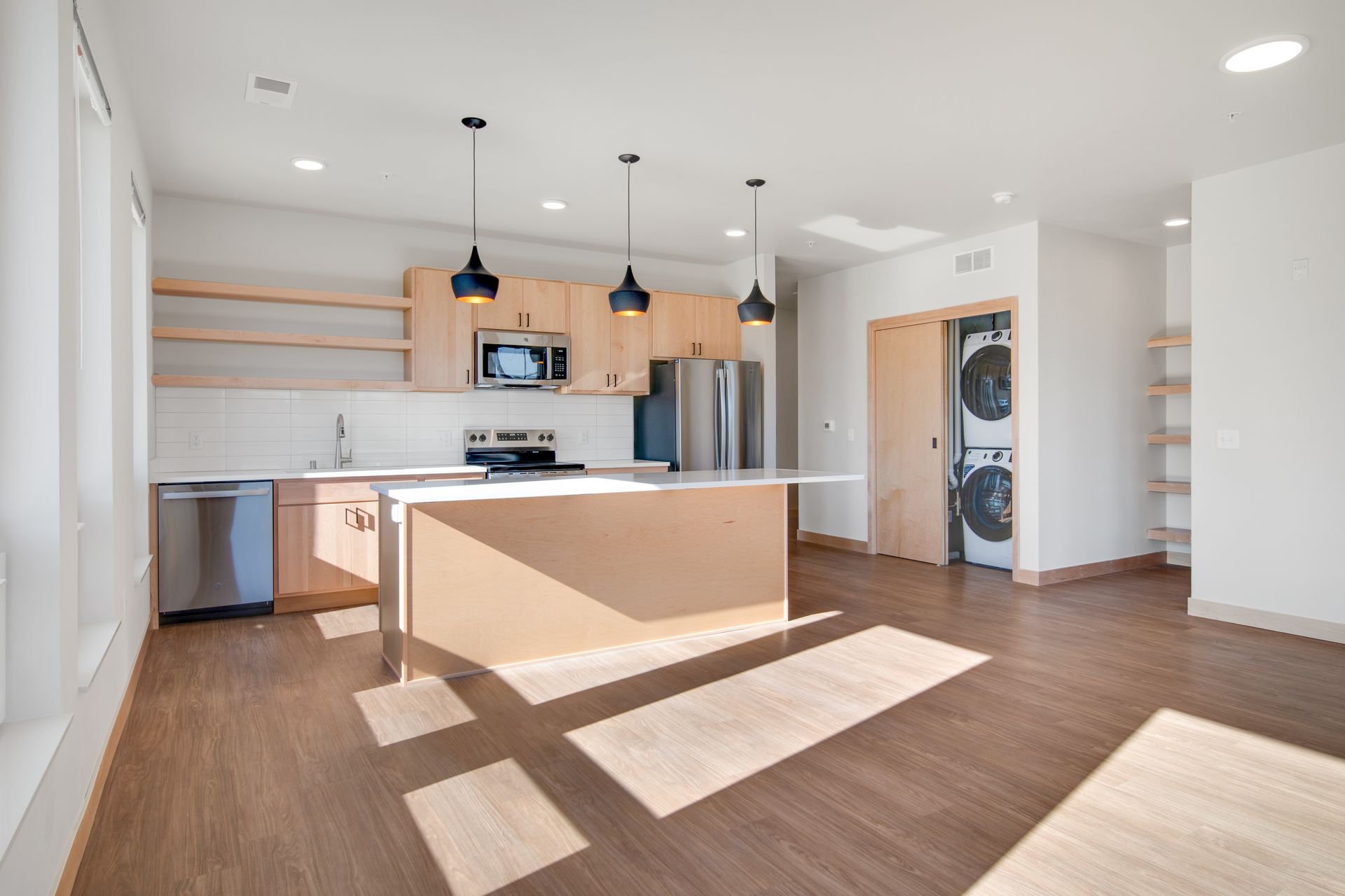 A kitchen with a large island in the middle of the room.