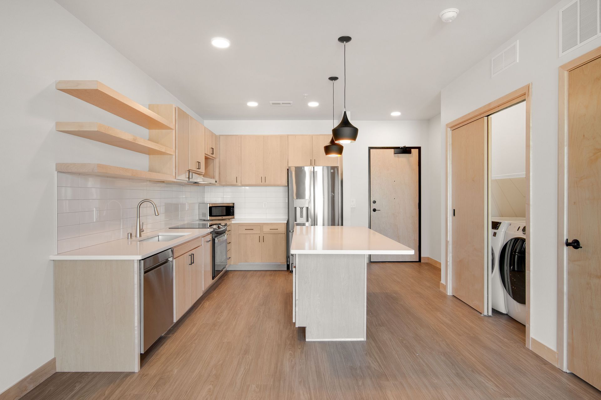 A kitchen with a large island in the middle of the room.