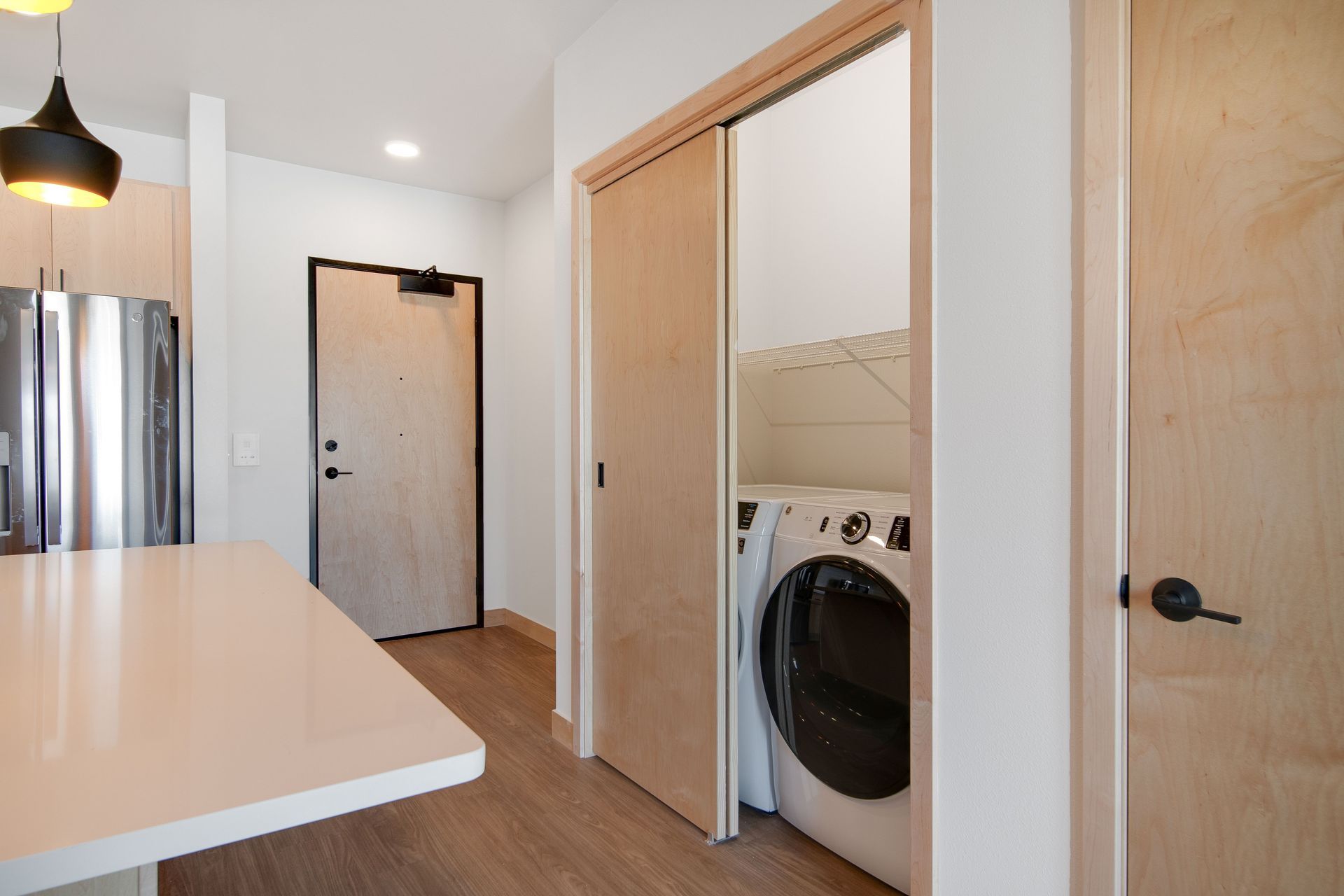 A laundry room with a washer and dryer in a closet.