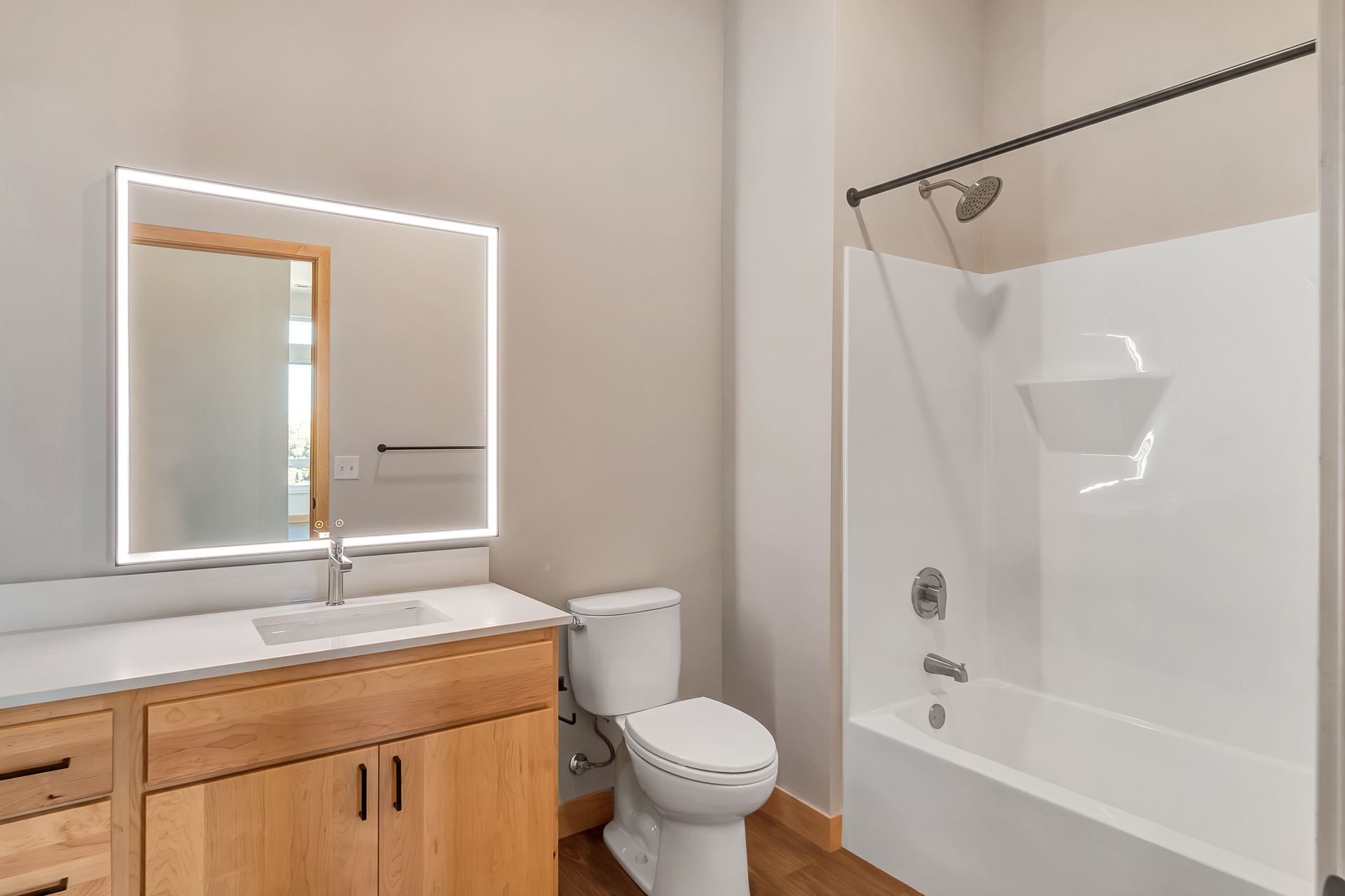 A bathroom with a toilet , sink , and bathtub.