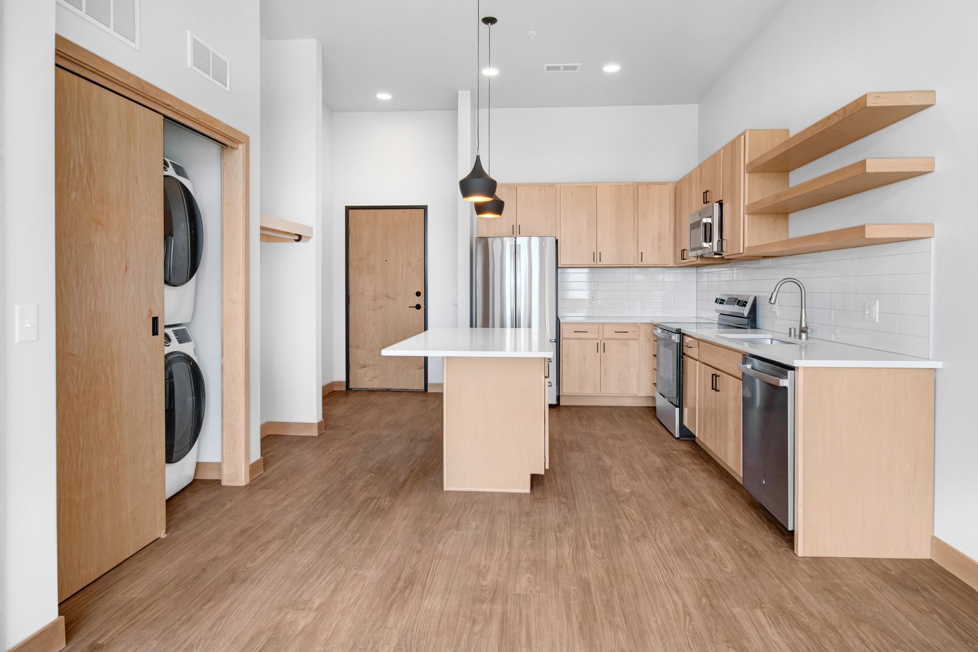 A kitchen with wooden cabinets and stainless steel appliances
