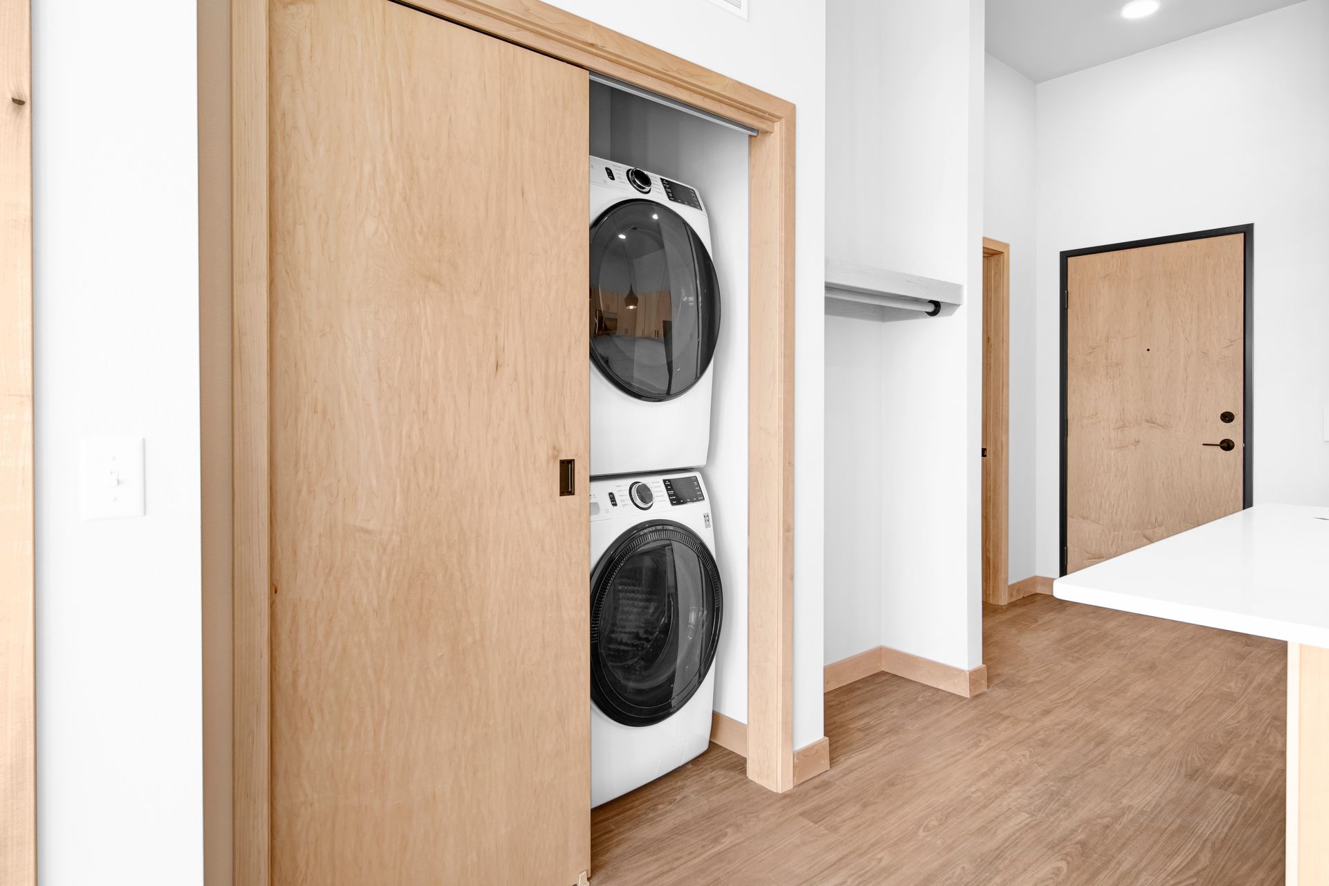 A washer and dryer are stacked on top of each other in a closet.