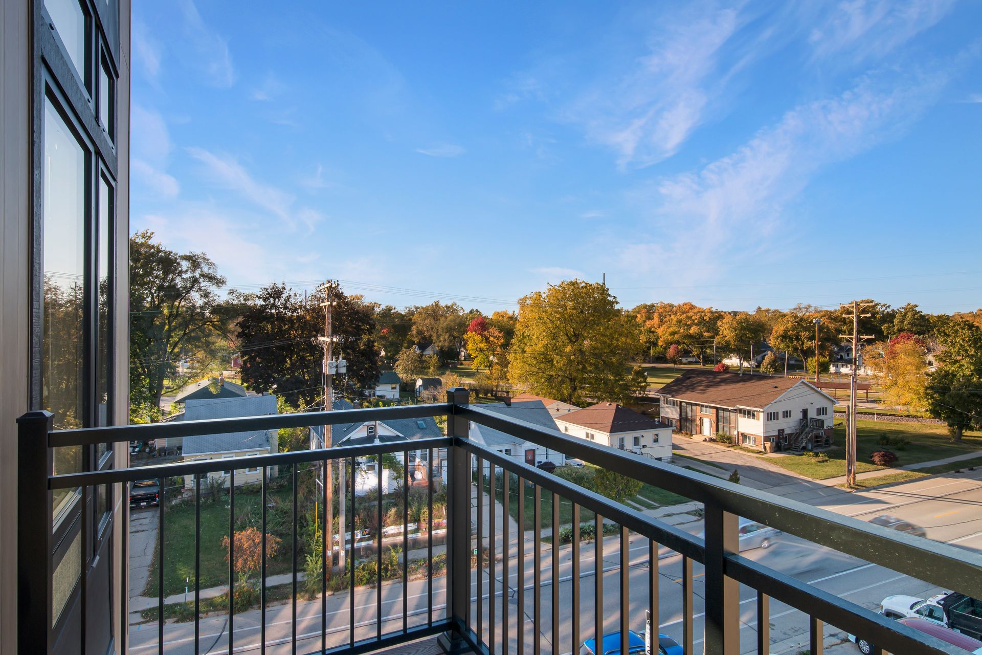 There is a balcony with a view of a city.