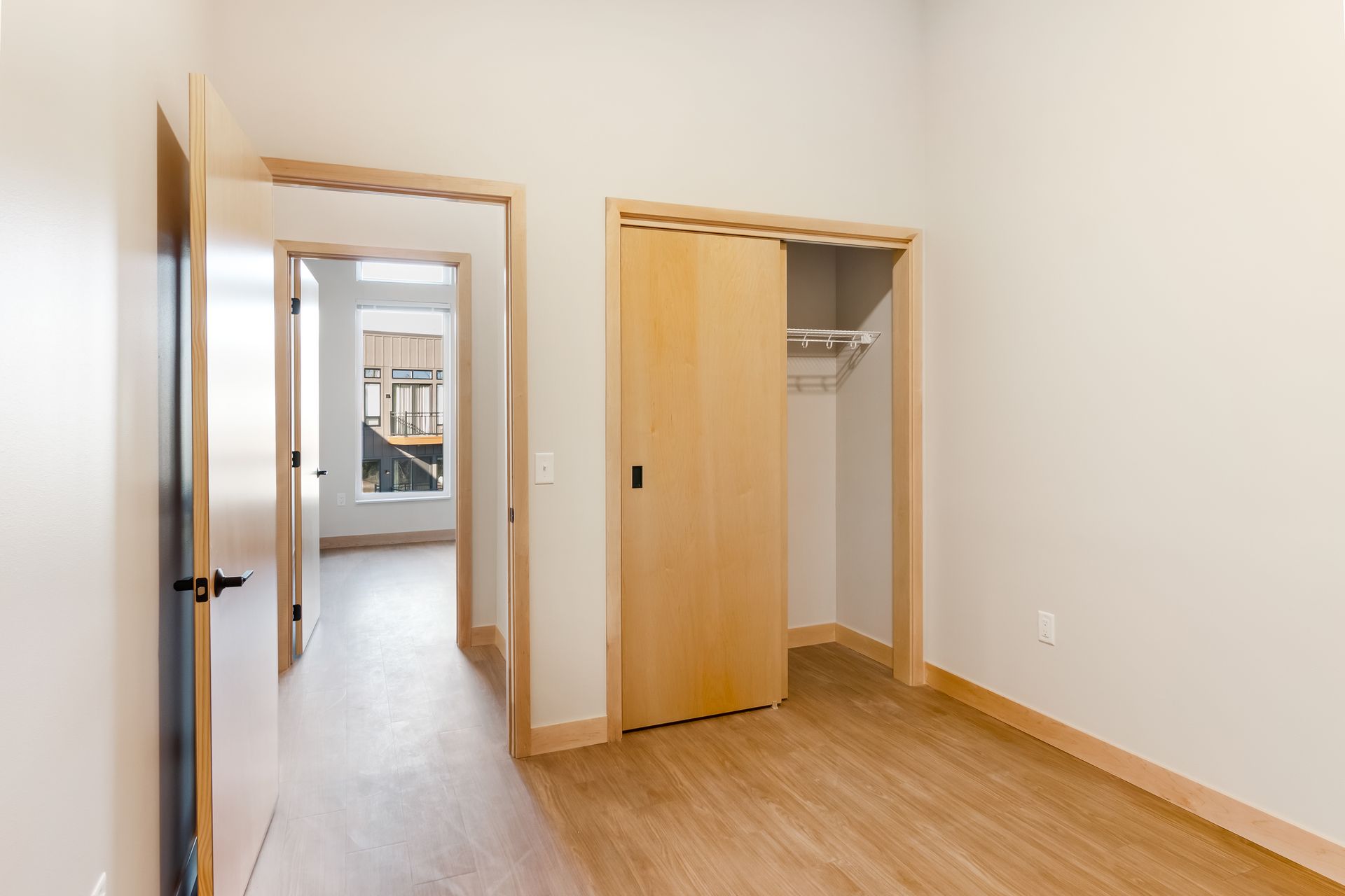 An empty room with a closet and a window