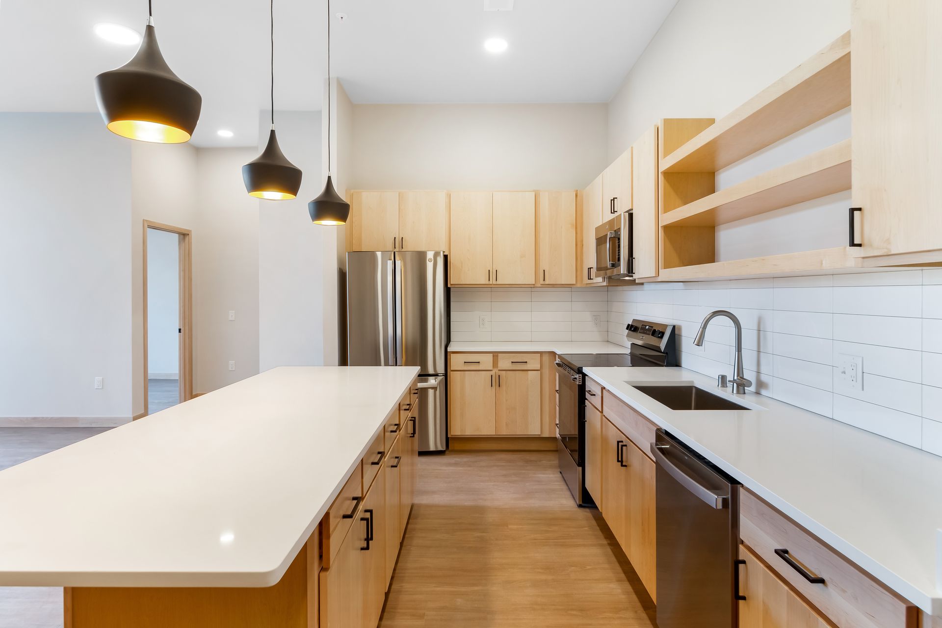 A kitchen with stainless steel appliances and wooden cabinets