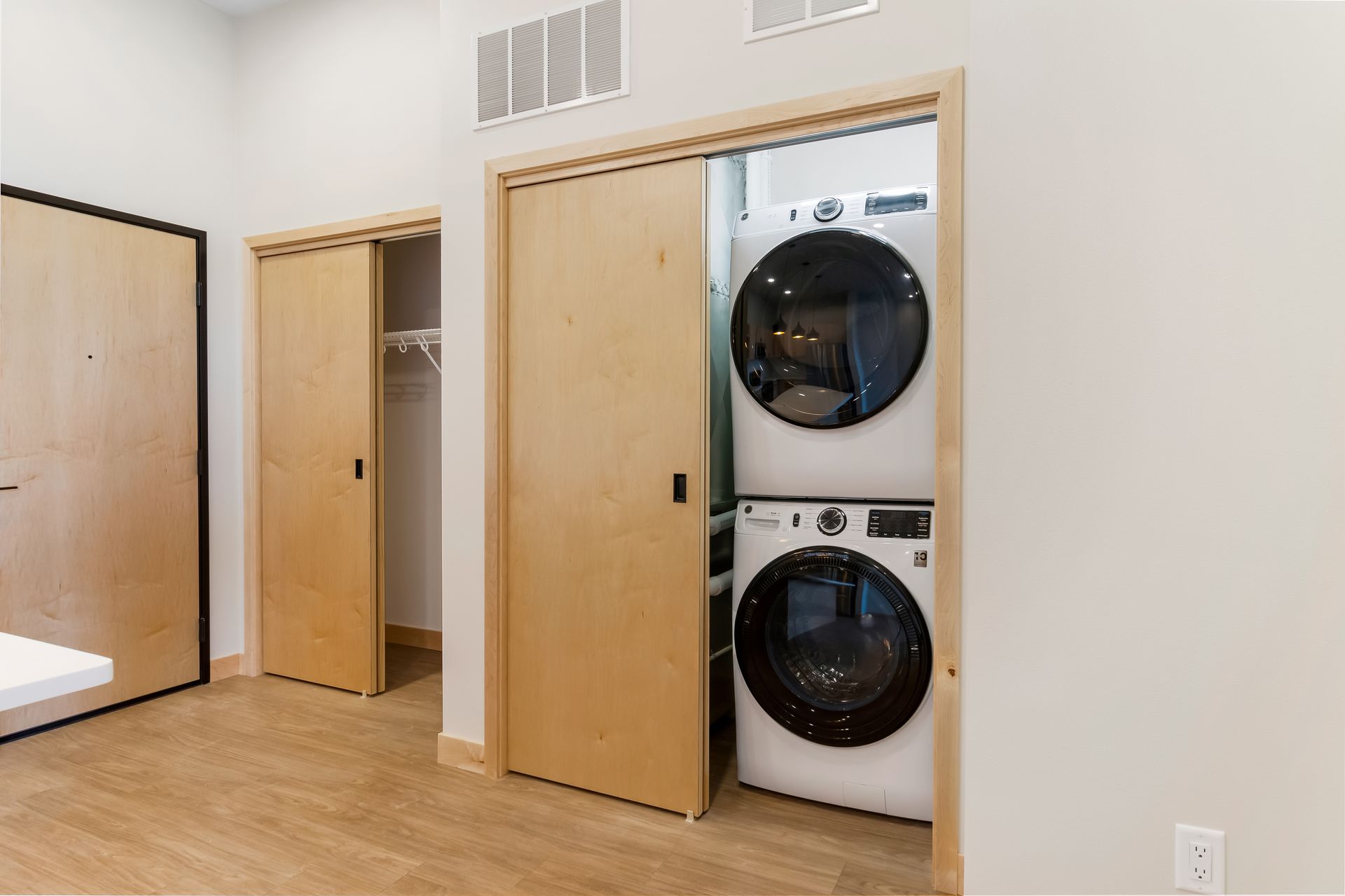 A washer and dryer are stacked on top of each other in a laundry room.