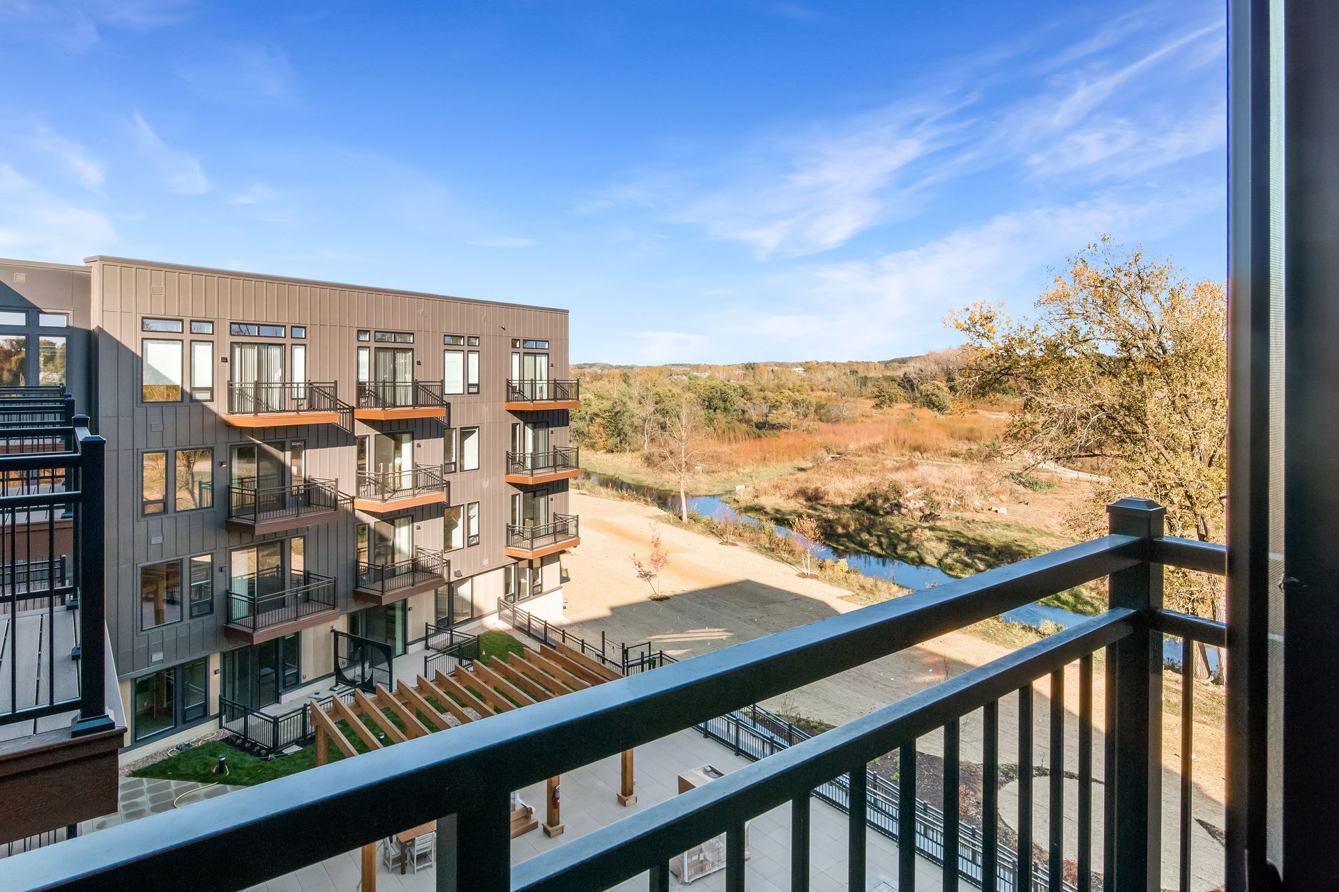 A balcony with a view of a building and a river.