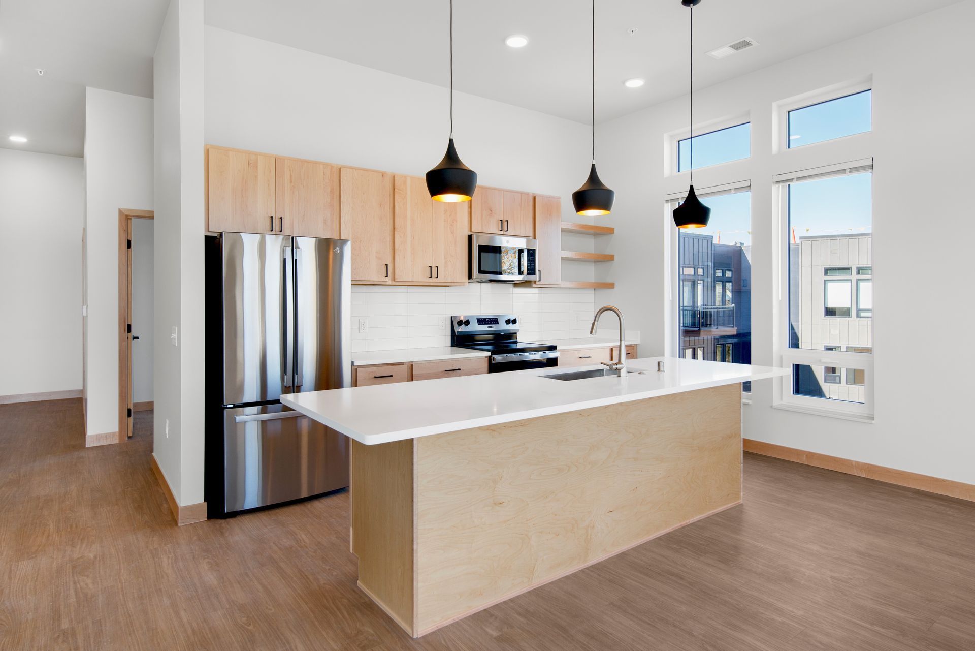 A kitchen with stainless steel appliances , wooden cabinets , and a large island.