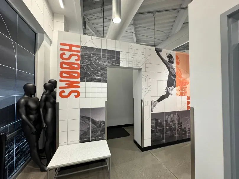 A room with a wall that says swoosh on it