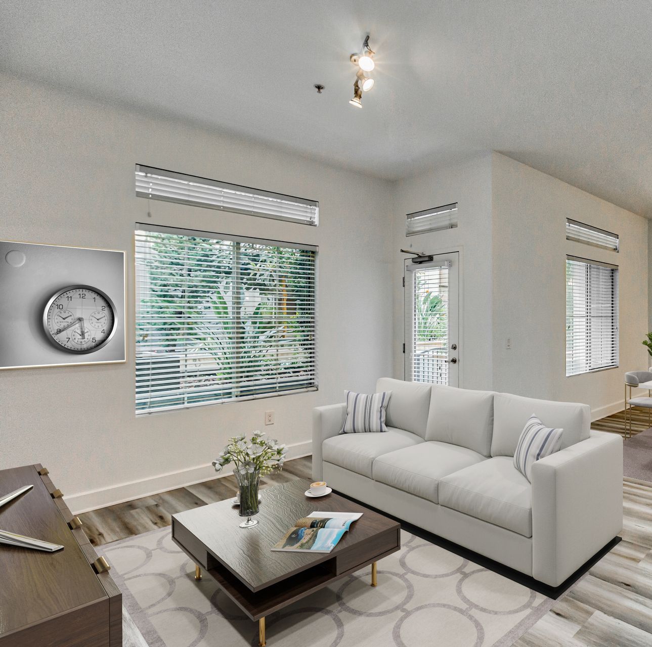 A living room with a white couch and a clock on the wall
