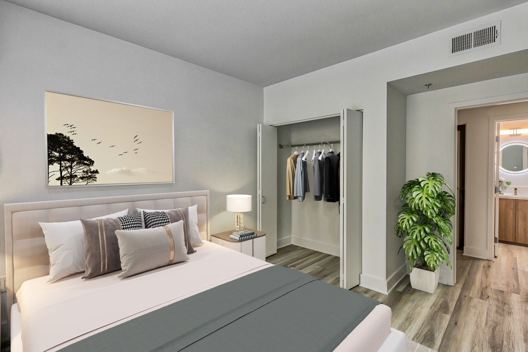 A bedroom with a large bed and a walk in closet.