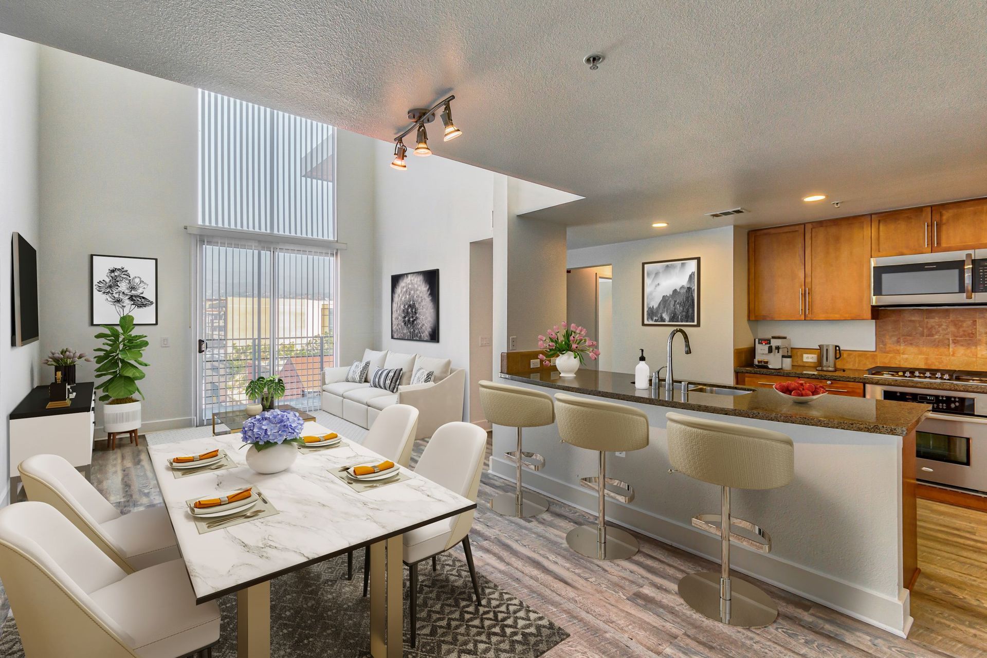 A living room with a dining table and chairs and a kitchen
