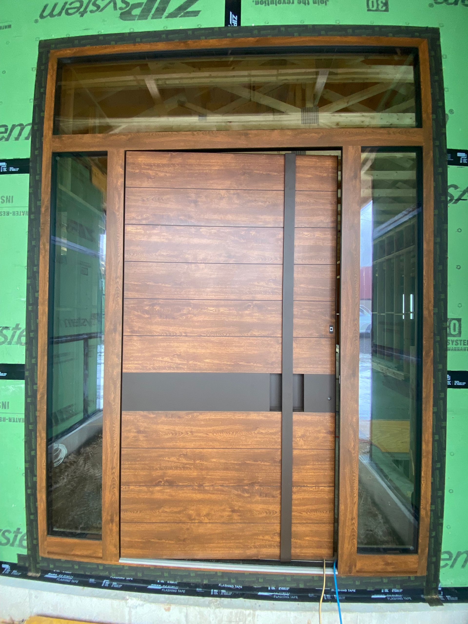A wooden door with a green wall behind it