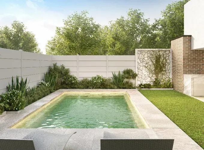 There is a small swimming pool in the backyard of a house.