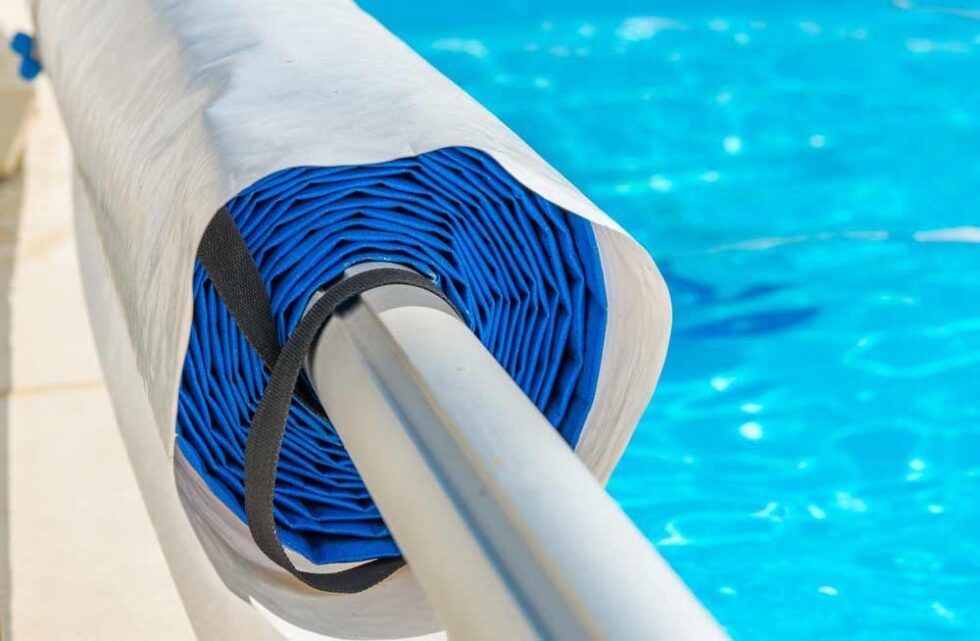 A Roll Of Blue Rope Is Attached To A Railing Next To A Swimming Pool — Evoke Pools In Lennox Head, NSW