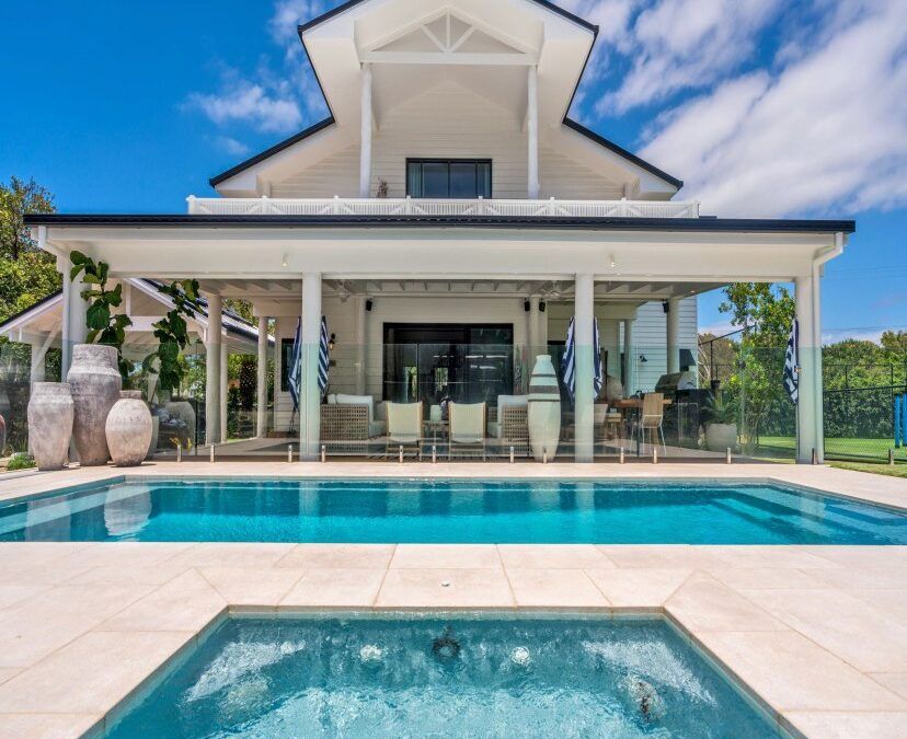 A Large House With A Swimming Pool And A Hot Tub In Front Of It — Evoke Pools In Lennox Head, NSW