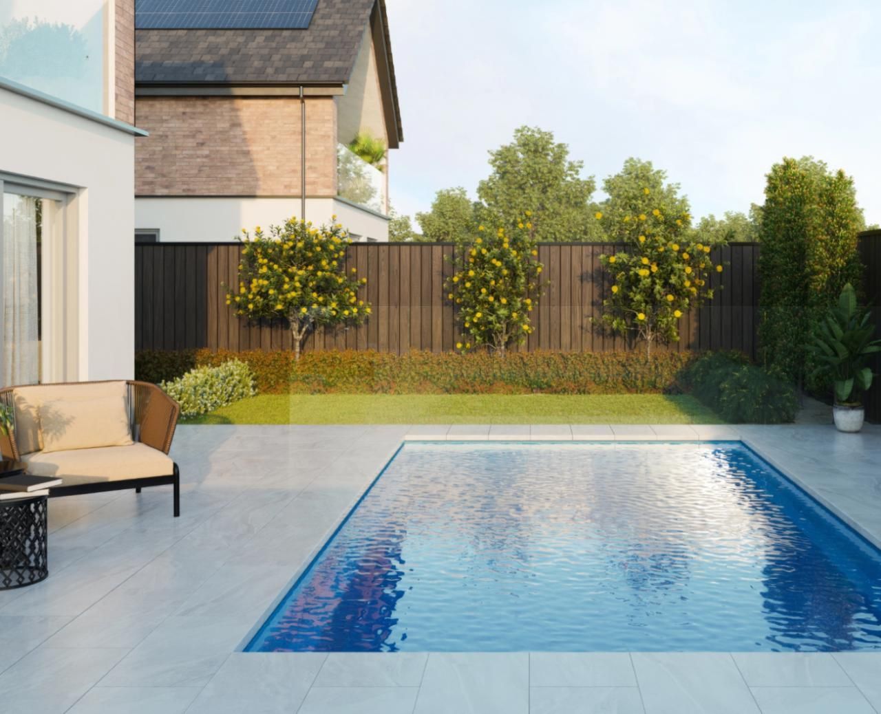 A large swimming pool is in the backyard of a house.