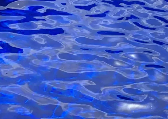 A close up of a blue water surface with waves