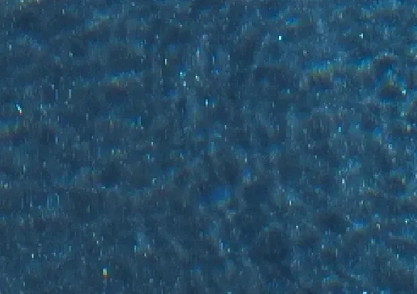 A close up of a blue carpet texture.
