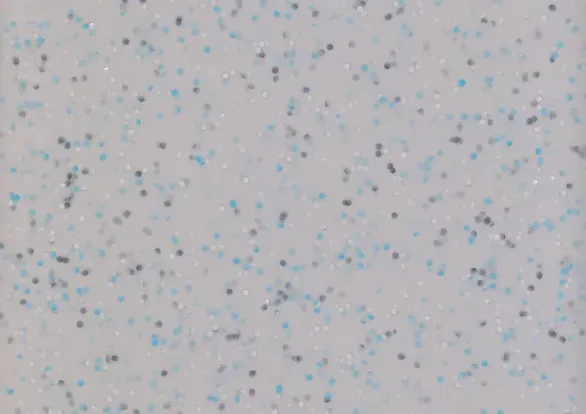 A close up of a white surface with blue dots on it.
