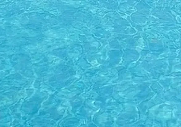A close up of a blue water surface in a swimming pool.