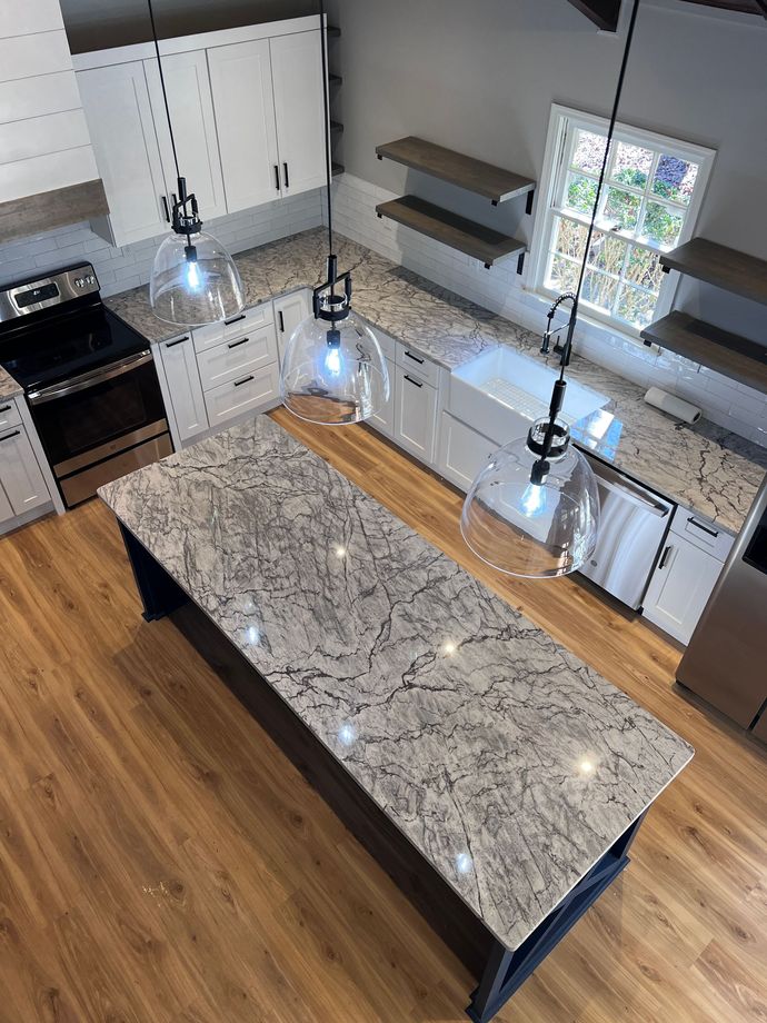 An aerial view of a kitchen with a large island in the middle.