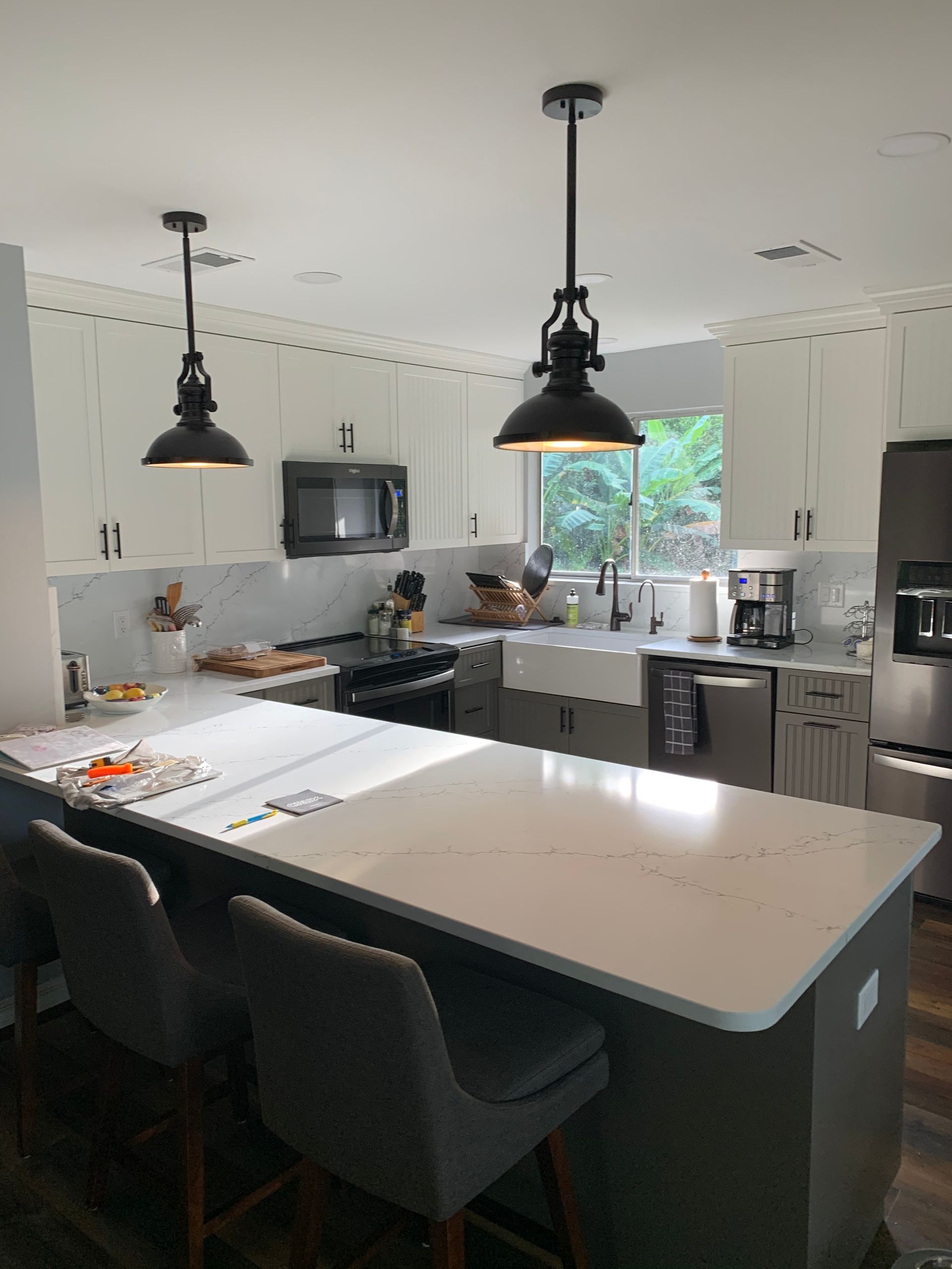 A kitchen with white cabinets and stainless steel appliances