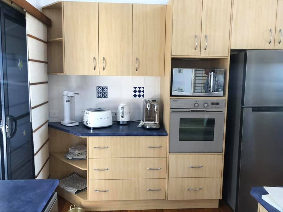 A Kitchen with Stainless Steel Appliances and Wooden Cabinets — Instyle Kitchens & Coatings in Ballina, NSW