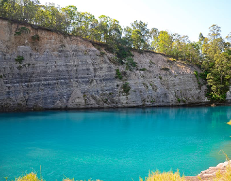 A Large Body of Water Surrounded by Rocks and Trees — Instyle Kitchens & Coatings in Lismore, NSW