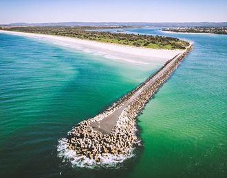 An Aerial View of A Pier in The Middle of The Ocean — Instyle Kitchens & Coatings in Ballina, NSW