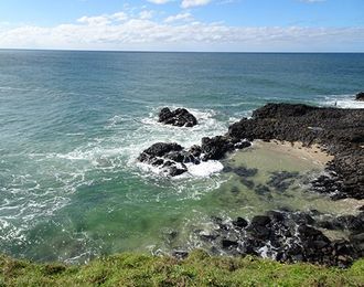 A View of The Ocean from A Cliff with Rocks in The Foreground — Instyle Kitchens & Coatings in Lennox Head, NSW