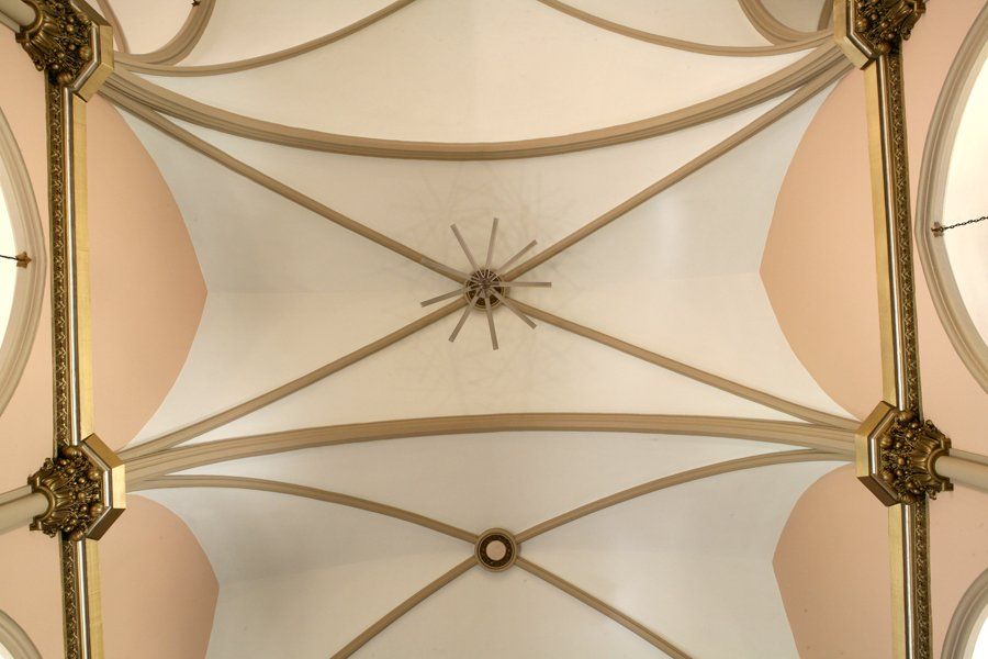 Looking up at the ceiling of a building with arches