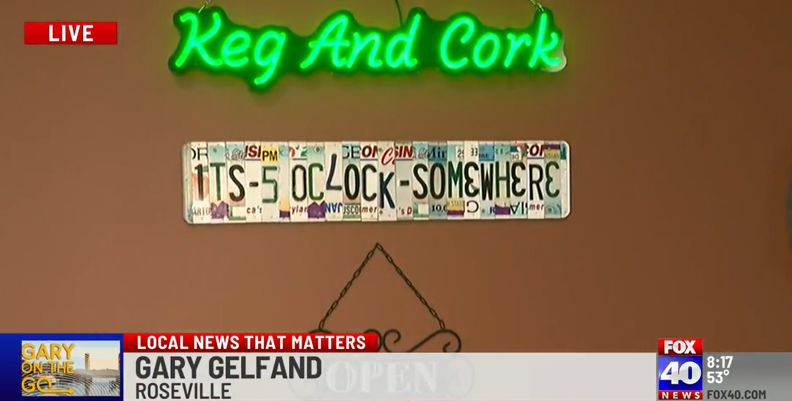 a sign that says keg and cork hangs on a wall
