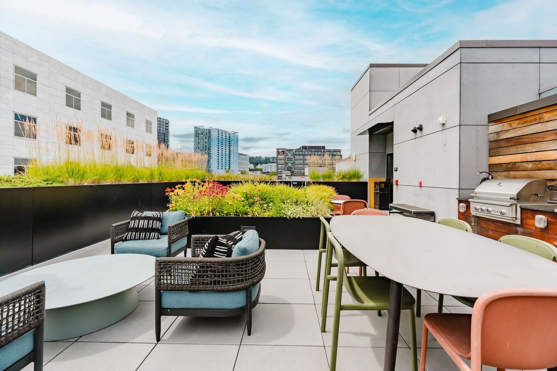 There is a table and chairs on the roof of a building.