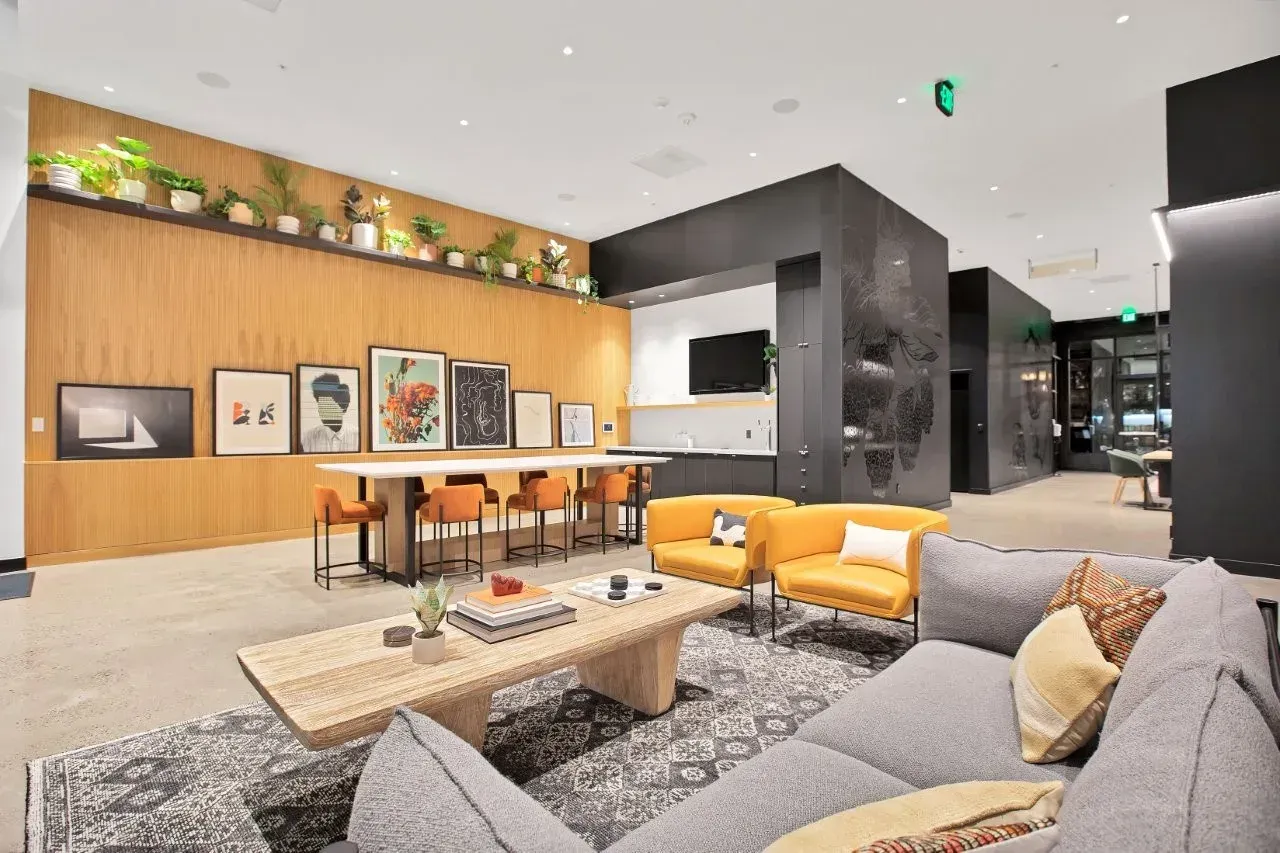 Clubhouse with a couch , chairs , a table and a coffee table.