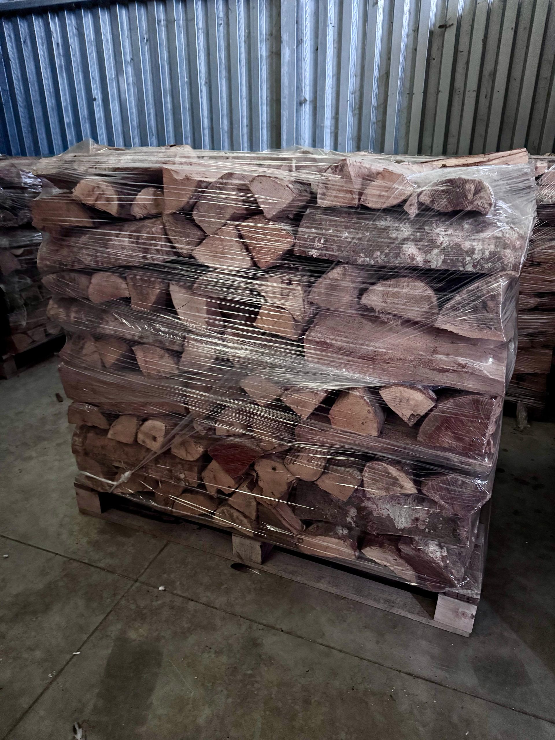 Una catasta di legna è posta sopra un pallet di legno.