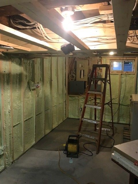 a room with a ladder and a light in it