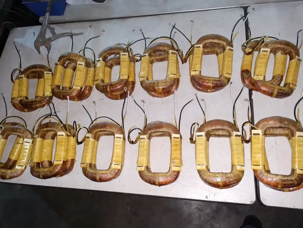 A bunch of copper coils are lined up on a table