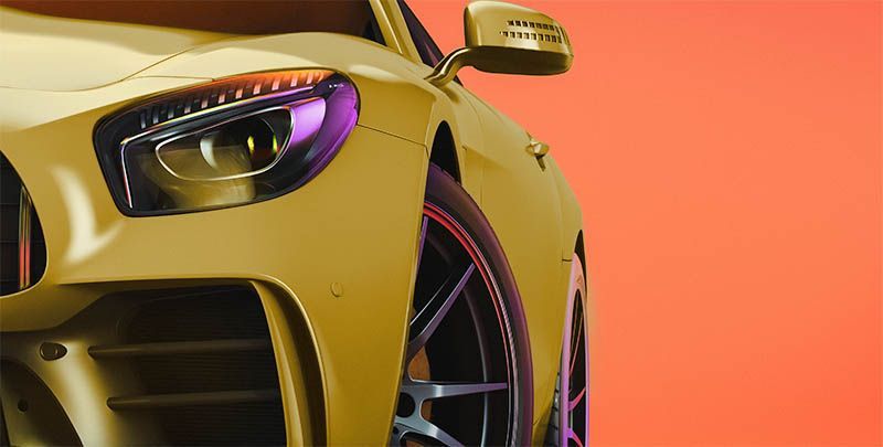 Yellow sports car front end with a sleek headlight and black wheel against an orange background