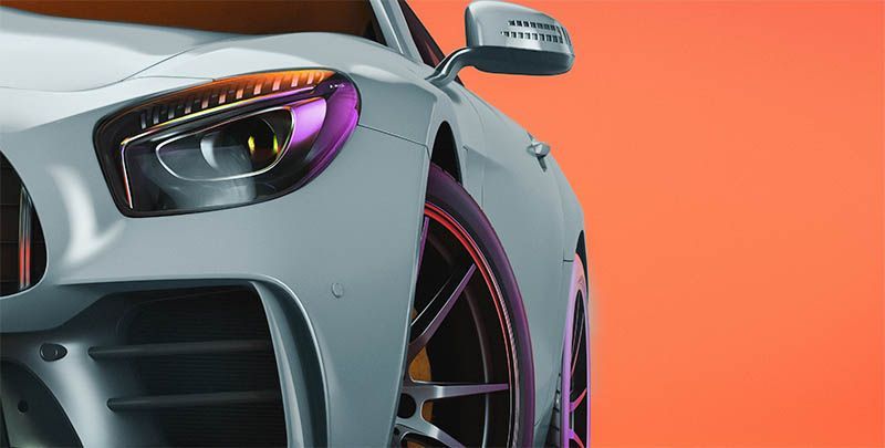 Close-up of a silver sports car front end with a colorful headlight and orange background