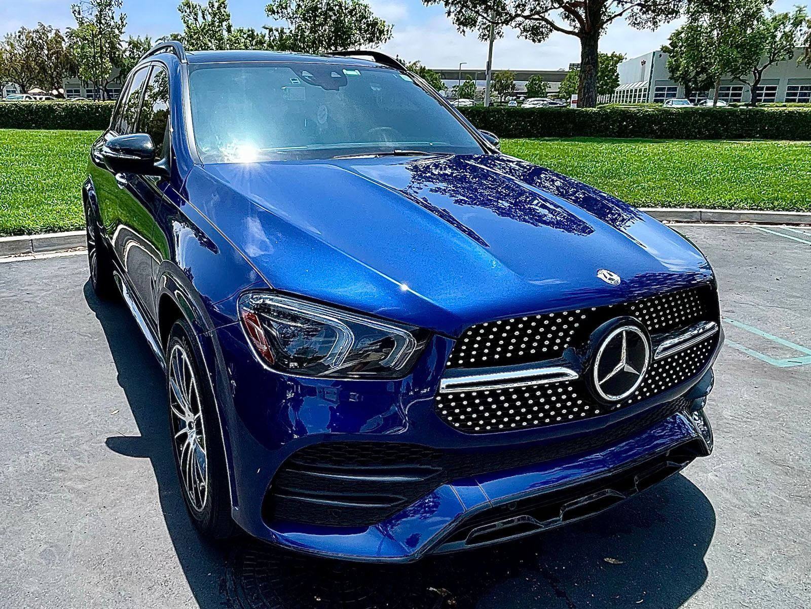 White Lamborghini sports car parked in front of graffiti-covered wall.