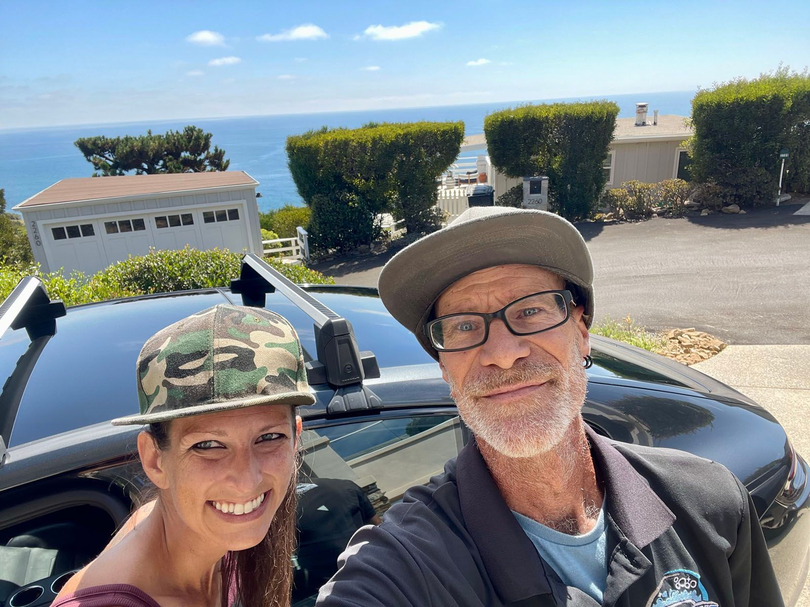 Blue BMW sedan parked on pavement. Black rims, sunny outdoor setting.