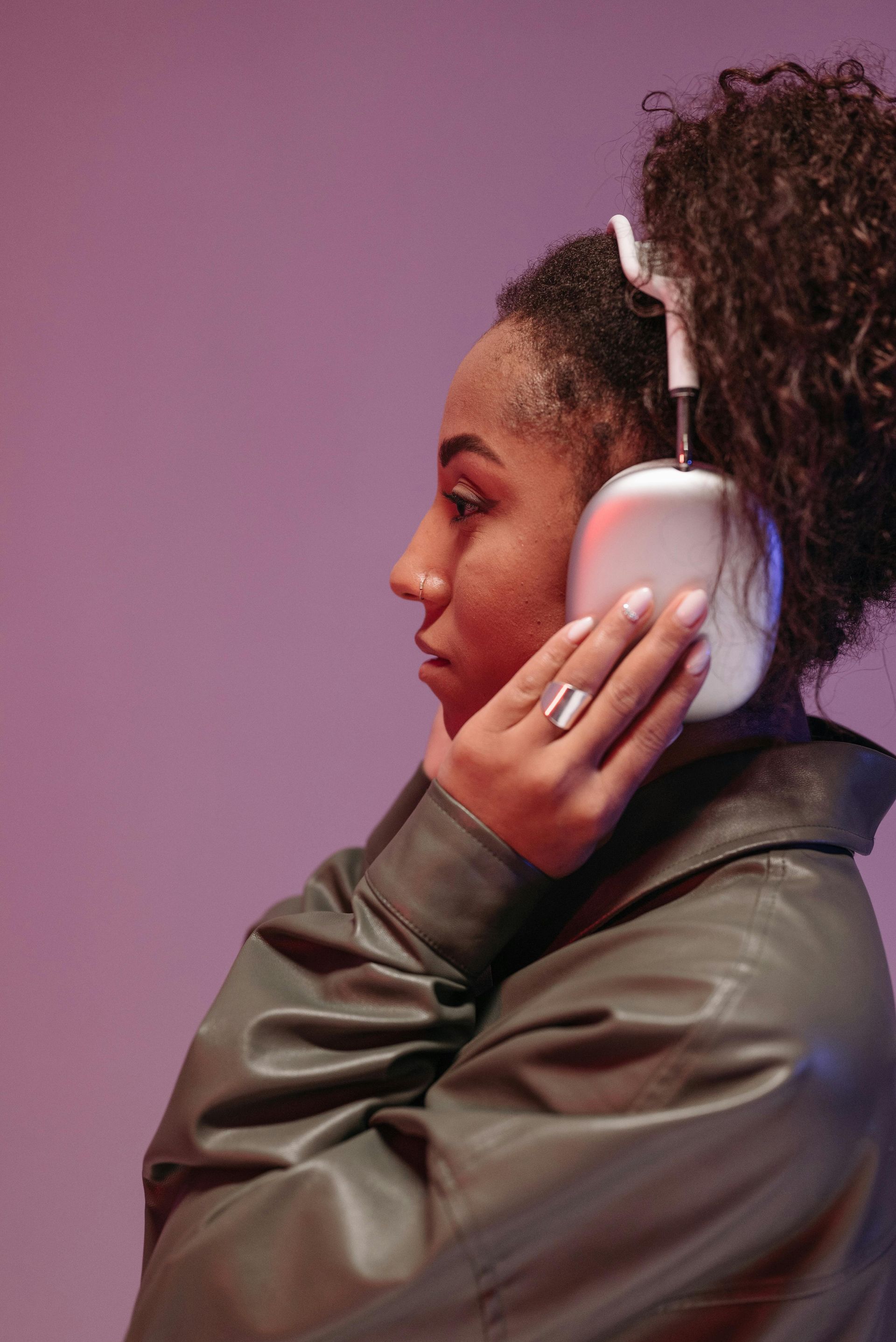 A pair of sleek, modern noise-canceling headphones resting on a still, quiet surface with soft, warm