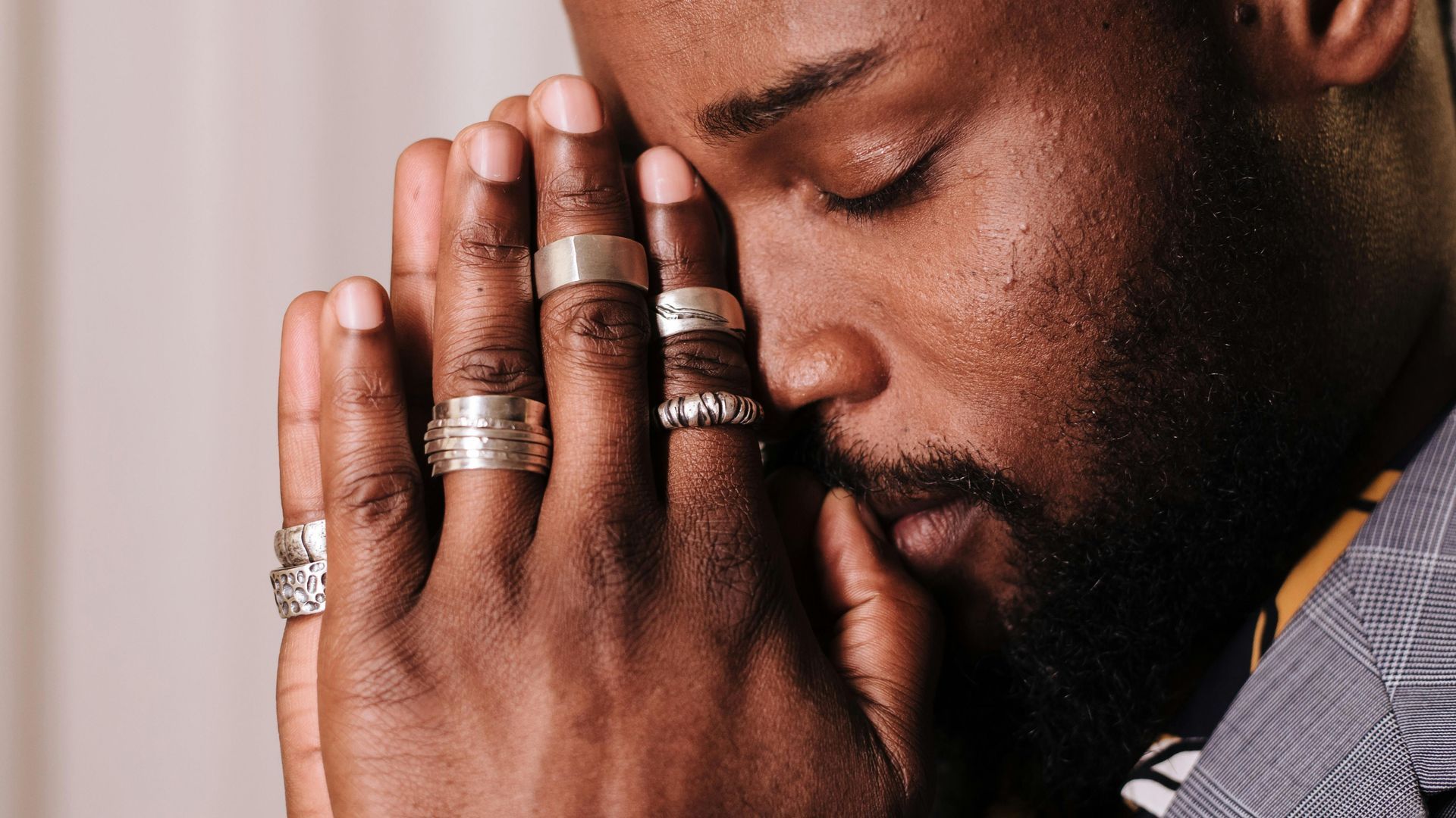 man pausing to reflect in prayer