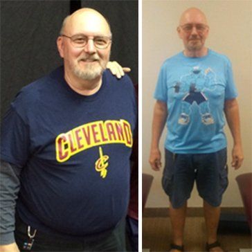 A man wearing a cleveland shirt is standing next to another man