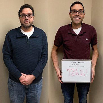 Two men are standing next to each other and one is holding a sign that says 726 lbs.