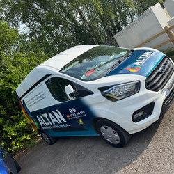 White ALTAN Plumbing & Heating Services van with blue and orange logo parked outdoors.
